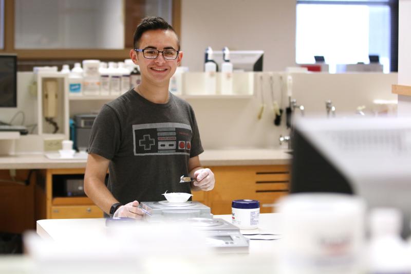 Student staring at camera smiling