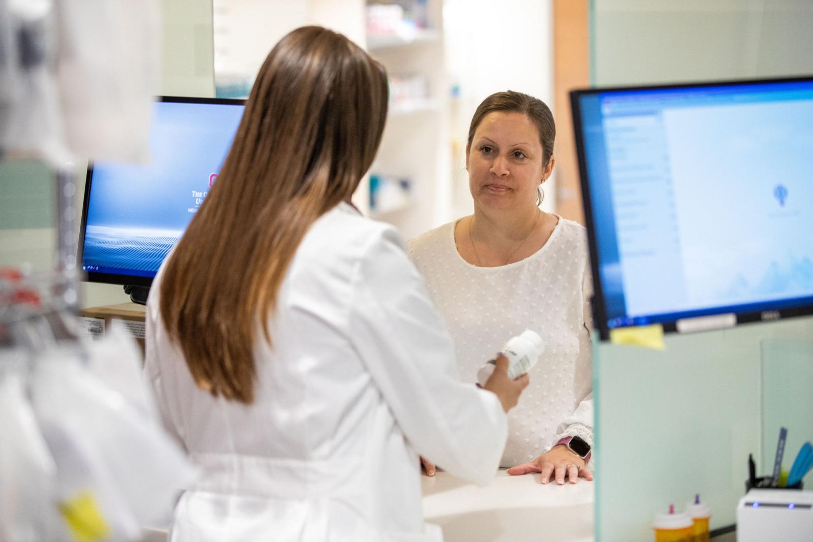 a pharmacist consulting with a patient